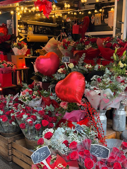 A vibrant display of fresh flowers and floral arrangements at Hornchurch High Street flower shop, showcasing red and white roses, carnations, and eucalyptus greenery, arranged in bouquets and wrapped